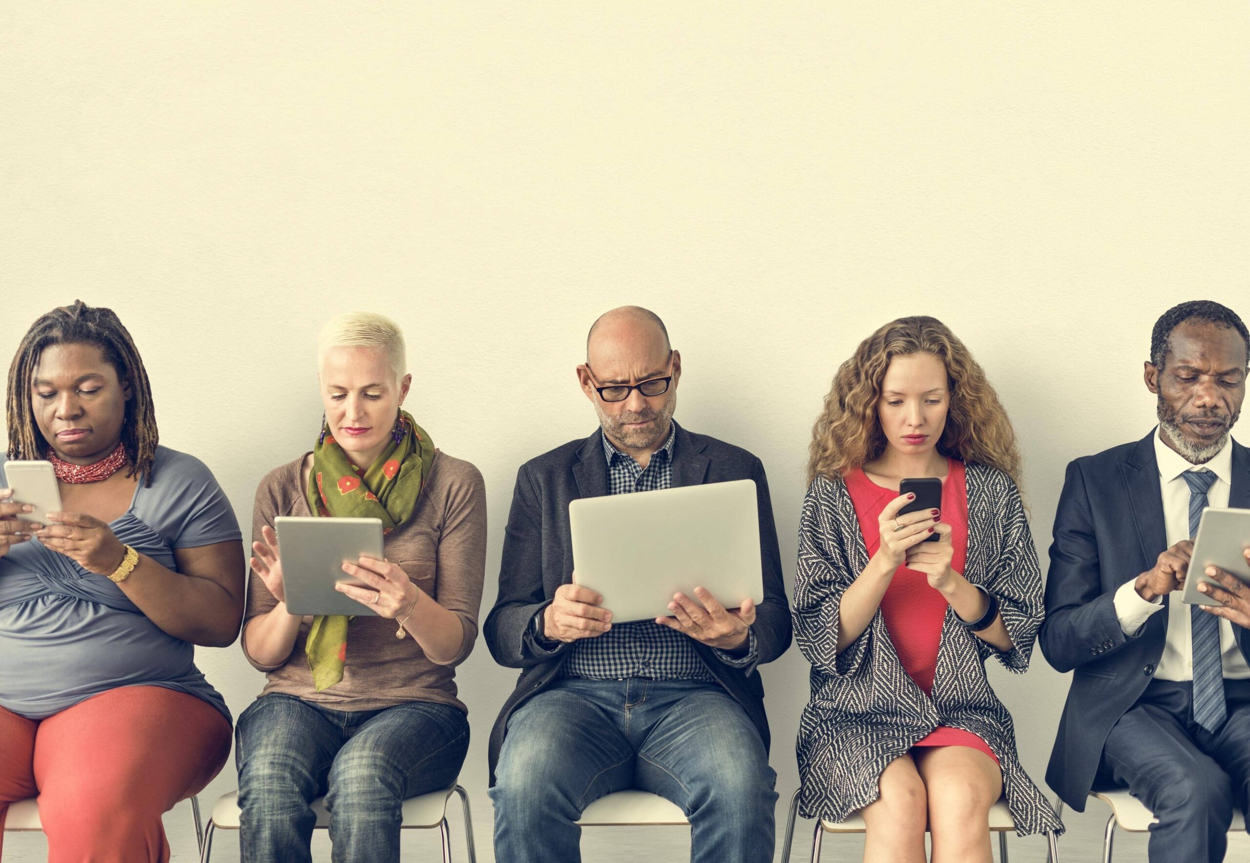 Diverse group of people reading content on digital devices